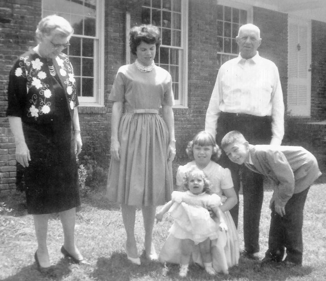 Grandmama and Granddaddy come for a visit, Easter Sunday 1963. That's Mama in the middle, of course, with Miriam, new sister Mary Baker, and me.